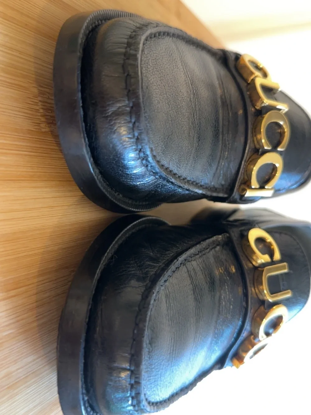 Gucci Black Leather Men’s Slip-On Loafers with Gold Logo Band